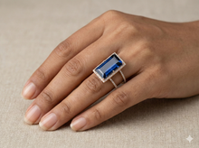 The Rose Gold Royal Blue Emerald Cut Halo Ring