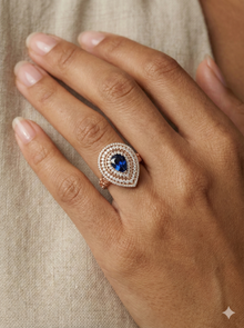 The Royal Blue Sapphire Pear Double Halo Ring